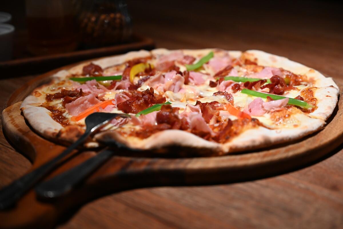 A wood-fired pizza fresh out of the oven